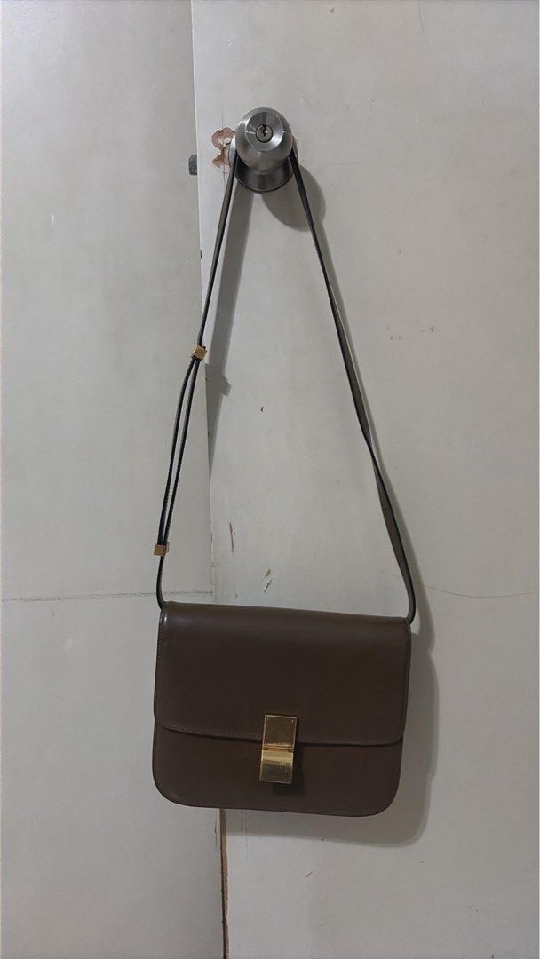 Celine Medium Classic Box Bag Brown Leather (Category: Luxury Bags & Wallets) located in Caloocan City. Submitted by theprelovedpurse (Listing ID 1469881392, Image 2). Description: - Brand: Celine - Style: Classic Box Bag - Color: Brown - Hardware: Gold-tone - Material: Leather with matching leather lining - Features: Structured silhouette, flap closure with metal clasp, adjustable shoulder strap, multiple interior compartments, zipped pocket, sl