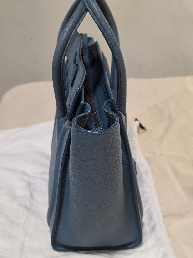 Celine Micro Luggage Tote (Category: Luxury Bags & Wallets) located in Paranaque City. Submitted by decluttering_by_anna (Listing ID 1469930044, Image 3). Description: - Brand: Céline - Style: Micro Luggage Tote - Material: Textured blue leather - Hardware: Silver tone with protective bottom feet - Features: Double rolled top handles, front zipper pocket, structured silhouette - Inclusions: Original Céline branded dust bag, bag organizer and Entr
