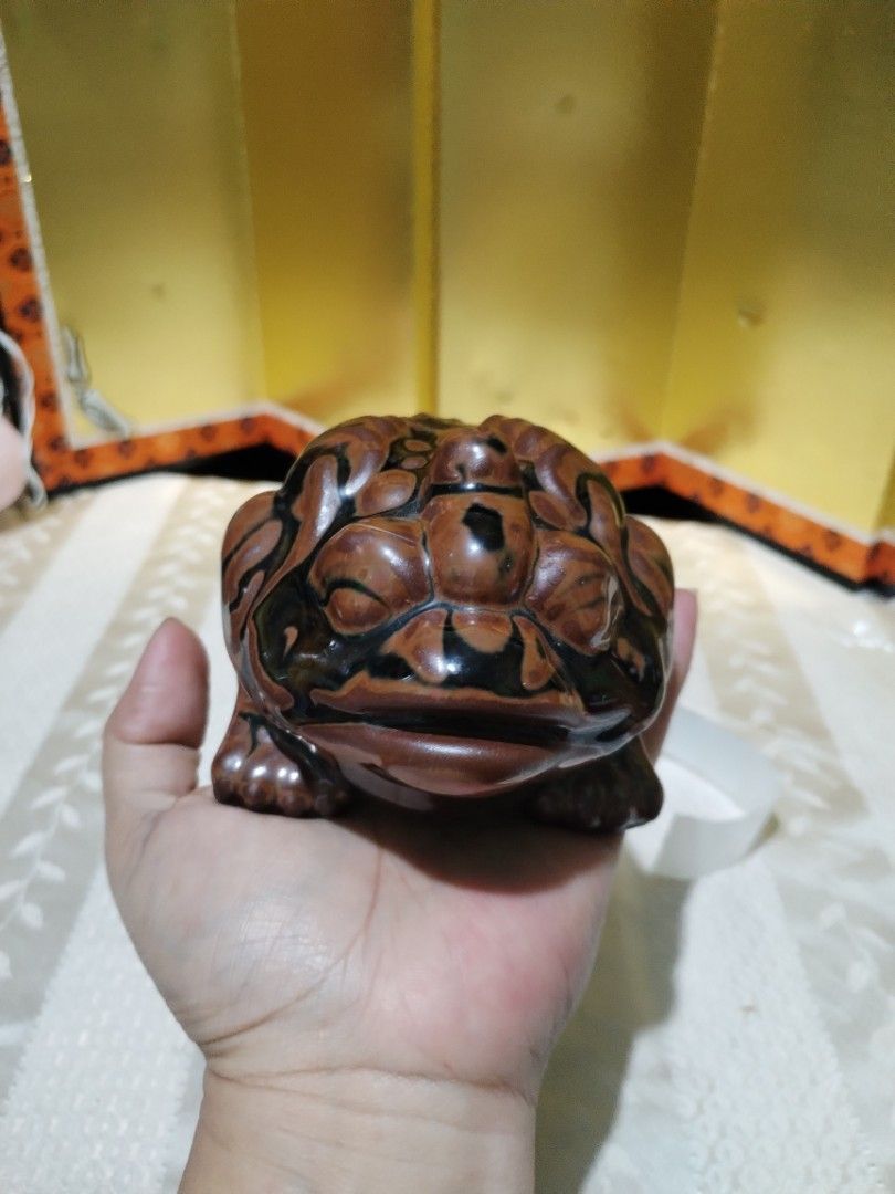 Ceramic frog figurine brown black glazed toad ornament sculpture (Category: Figurines & Statues) located in La Trinidad. Submitted by malditas (Listing ID 1469919655, Image 2). Description: - Brown and black glazed ceramic frog figurine - Detailed texture on the back and head with a heavy glossy finish - Hollow base with three feet underneath - Unique handmade look, perfect for desks or shelves - Great decorative accent for any space From HT box 