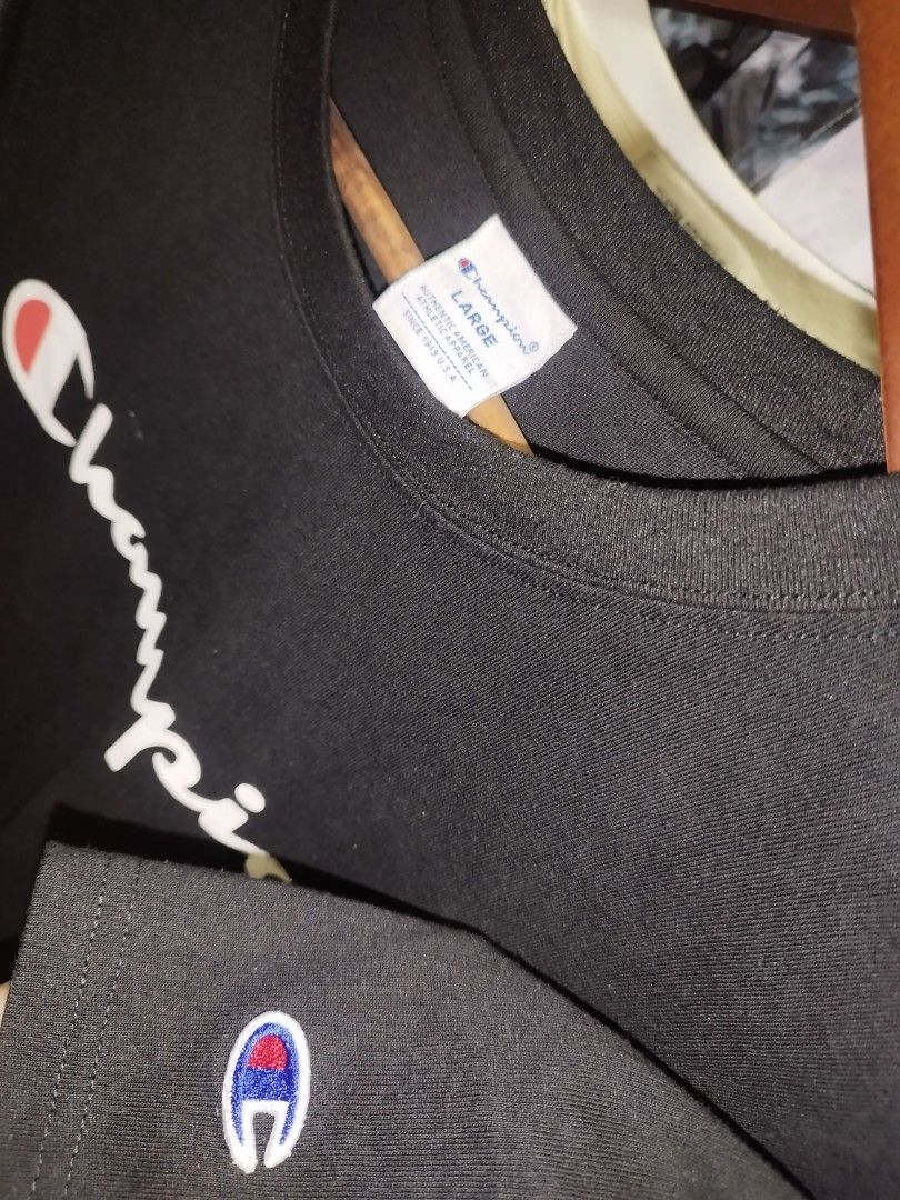 Champion Black Script Logo T-Shirt Size Large (Category: Tshirts & Polo Shirts ) located in Tuguegarao City. Submitted by ZeevLim (Listing ID 1469880822, Image 2). Description: - Brand: Champion - Style: Classic streetwear crewneck t-shirt - Color: Black with large script logo across the chest - Details: Small embroidered Champion 'C' logo patch on the left sleeve - Size: Large - Material: Solid, high-quality cotton - Fit: Standard short sleeve f