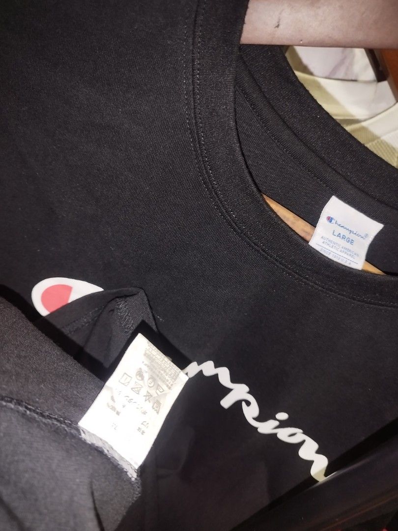 Champion Black Script Logo T-Shirt Size Large (Category: Tshirts & Polo Shirts ) located in Tuguegarao City. Submitted by ZeevLim (Listing ID 1469880822, Image 3). Description: - Brand: Champion - Style: Classic streetwear crewneck t-shirt - Color: Black with large script logo across the chest - Details: Small embroidered Champion 'C' logo patch on the left sleeve - Size: Large - Material: Solid, high-quality cotton - Fit: Standard short sleeve f