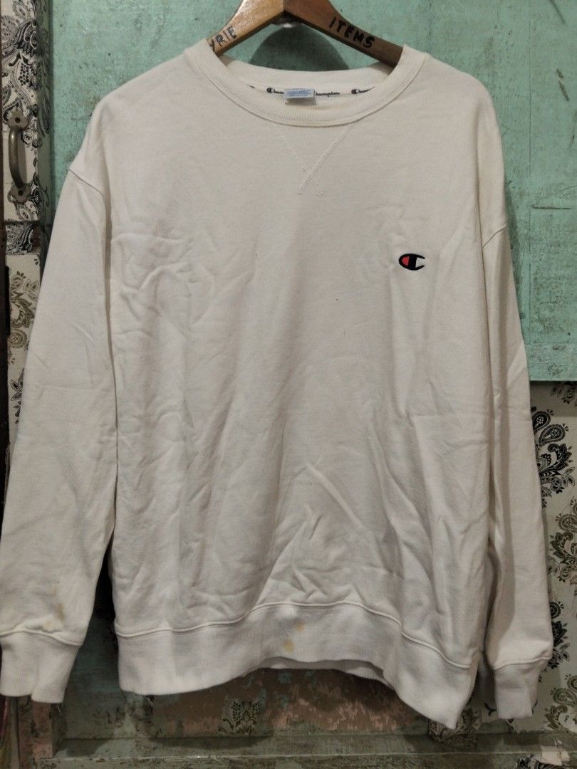 Champion C3-K340 White Sweatshirt Large Big Back Script Logo (Category: Coats, Jackets and Outerwear) located in Baguio. Submitted by jnjayceelbrn (Listing ID 1469837281, Image 1). Description: - Brand: Champion - Style Code: C3-K340 - Size: Large - Material: 100% Cotton - Design: Embroidered mini logo on chest and large blue script logo across the back - Details: Ribbed cuffs and hem - Condition: Pre-owned with noticeable yellowish stains near t