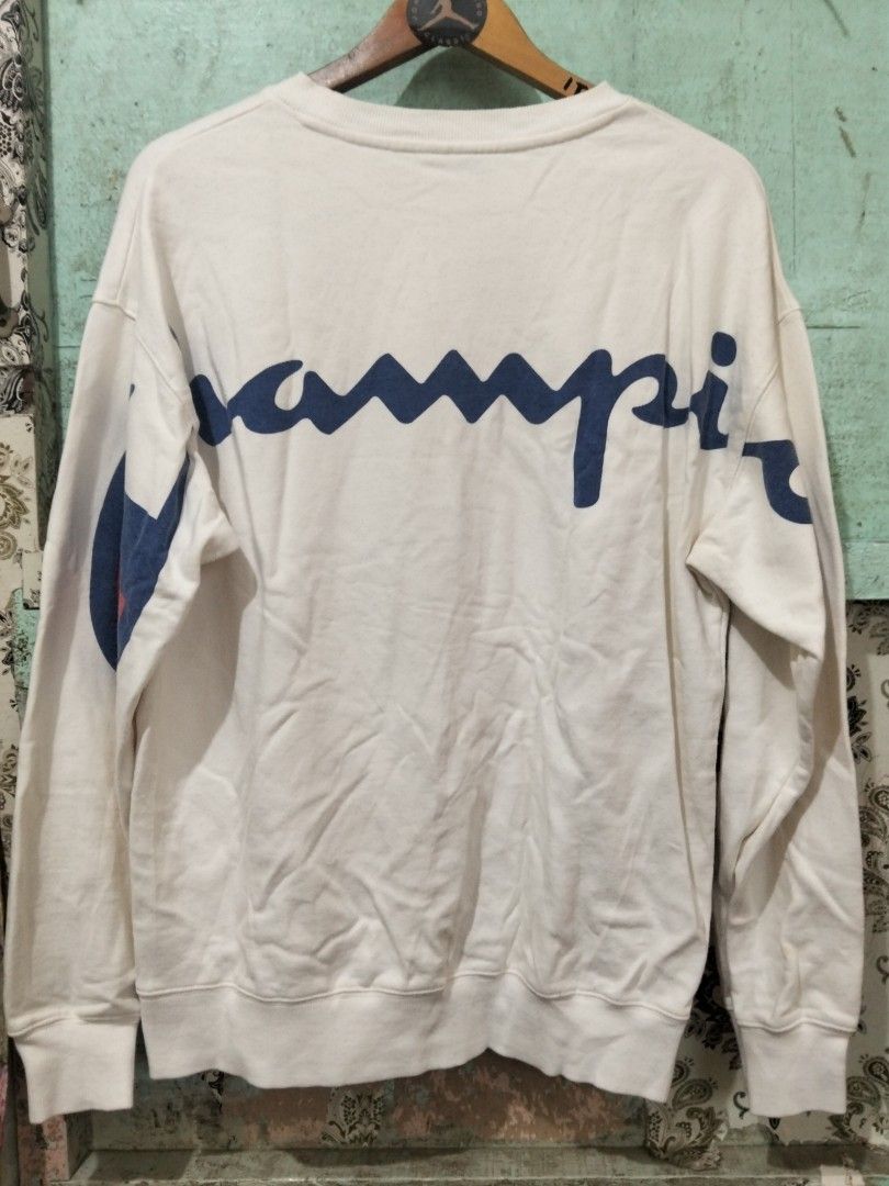 Champion C3-K340 White Sweatshirt Large Big Back Script Logo (Category: Coats, Jackets and Outerwear) located in Baguio. Submitted by jnjayceelbrn (Listing ID 1469837281, Image 2). Description: - Brand: Champion - Style Code: C3-K340 - Size: Large - Material: 100% Cotton - Design: Embroidered mini logo on chest and large blue script logo across the back - Details: Ribbed cuffs and hem - Condition: Pre-owned with noticeable yellowish stains near t