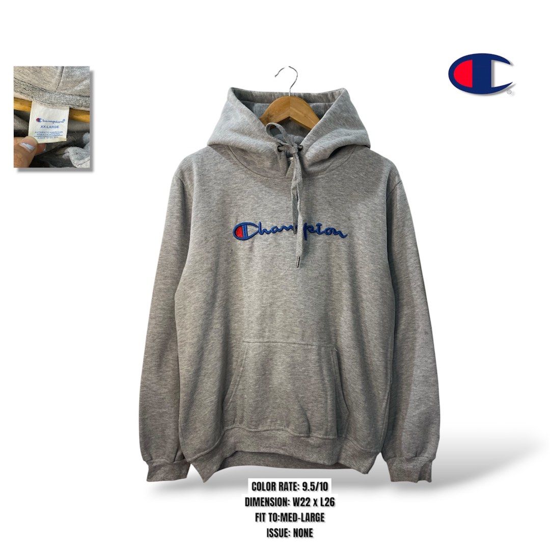 Champion Grey Script Logo Hoodie XX-Large (Category: Hoodies) located in Cabagan. Submitted by blessingma81004 (Listing ID 1469767471, Image 1). Description: - Brand: Champion - Color: Grey with embroidered blue script logo - Features: Kangaroo front pocket, adjustable drawstring hood - Size: Tagged XX-Large (fits like a Medium-Large based on measurements).