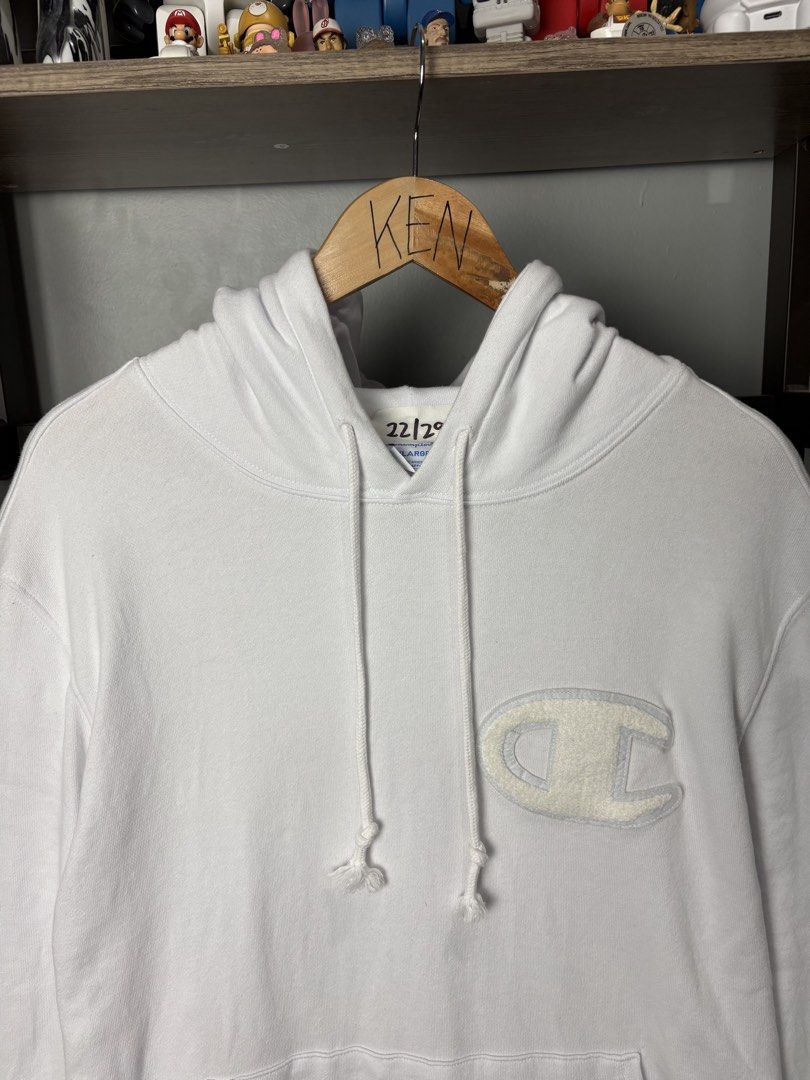 Champion White Hoodie XXLarge (Category: Hoodies) located in Manila. Submitted by thriftnikenv.2 (Listing ID 1469865277, Image 3). Description: - Brand: Champion - Size: XXLarge (2XL) - Color: Classic White - Material: 100% Cotton (Made in Indonesia) - Design: Large chenille C logo patch on the chest - Details: Kangaroo front pocket, drawstring hood, ribbed cuffs, and embroidered sleeve patch - Condition: Excellent, ready to wear.