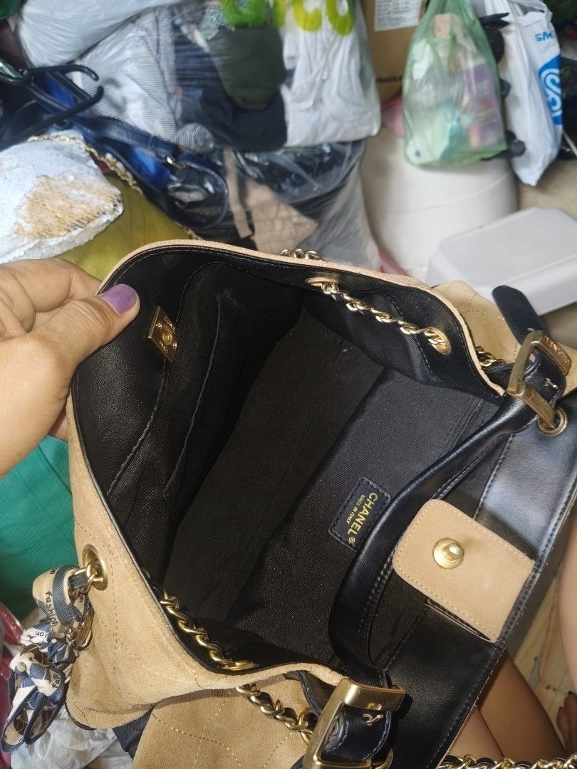 Chanel Two-Tone Suede and Leather Handbag (Category: Luxury Bags & Wallets) located in Manila. Submitted by arlene.07 (Listing ID 1469773567, Image 1). Description: - Material: Premium tan suede and black leather with gold-tone hardware - Design: Elegant quilted pattern featuring a front CC logo - Interior: Black fabric lining with a convenient zippered pocket and brand tag - Strap: Stylish chain handles accented with a removable patterned scarf 