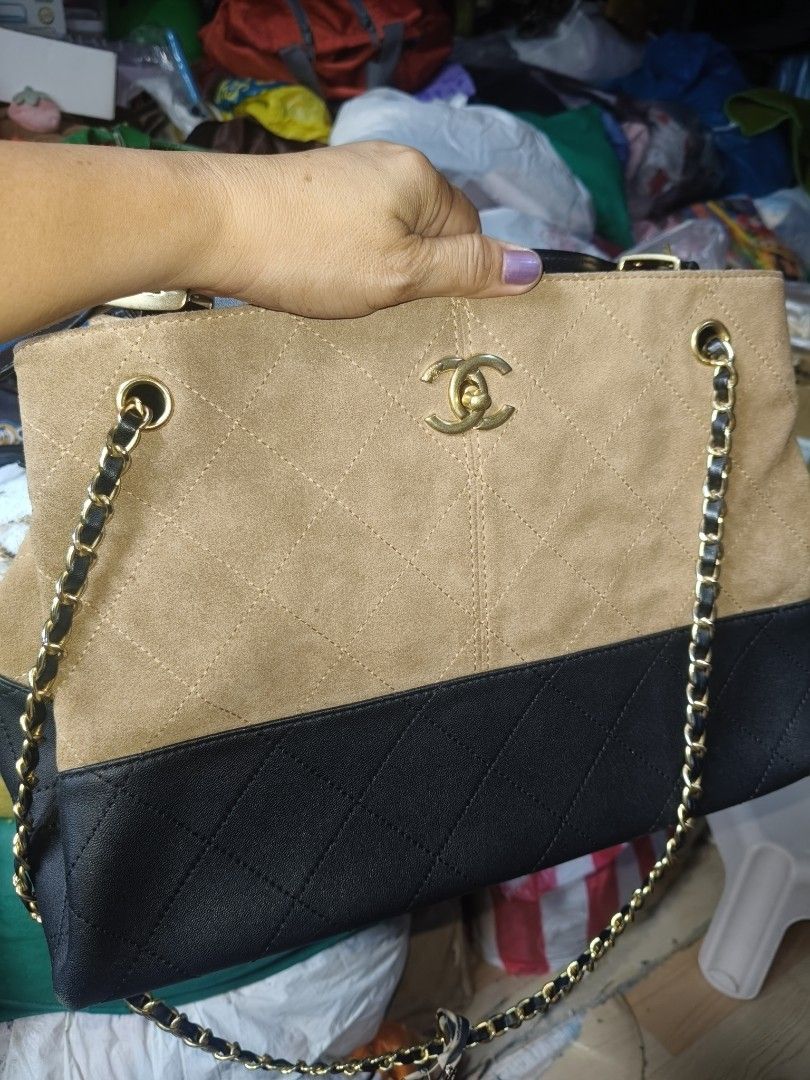 Chanel Two-Tone Suede and Leather Handbag (Category: Luxury Bags & Wallets) located in Manila. Submitted by arlene.07 (Listing ID 1469773567, Image 3). Description: - Material: Premium tan suede and black leather with gold-tone hardware - Design: Elegant quilted pattern featuring a front CC logo - Interior: Black fabric lining with a convenient zippered pocket and brand tag - Strap: Stylish chain handles accented with a removable patterned scarf 