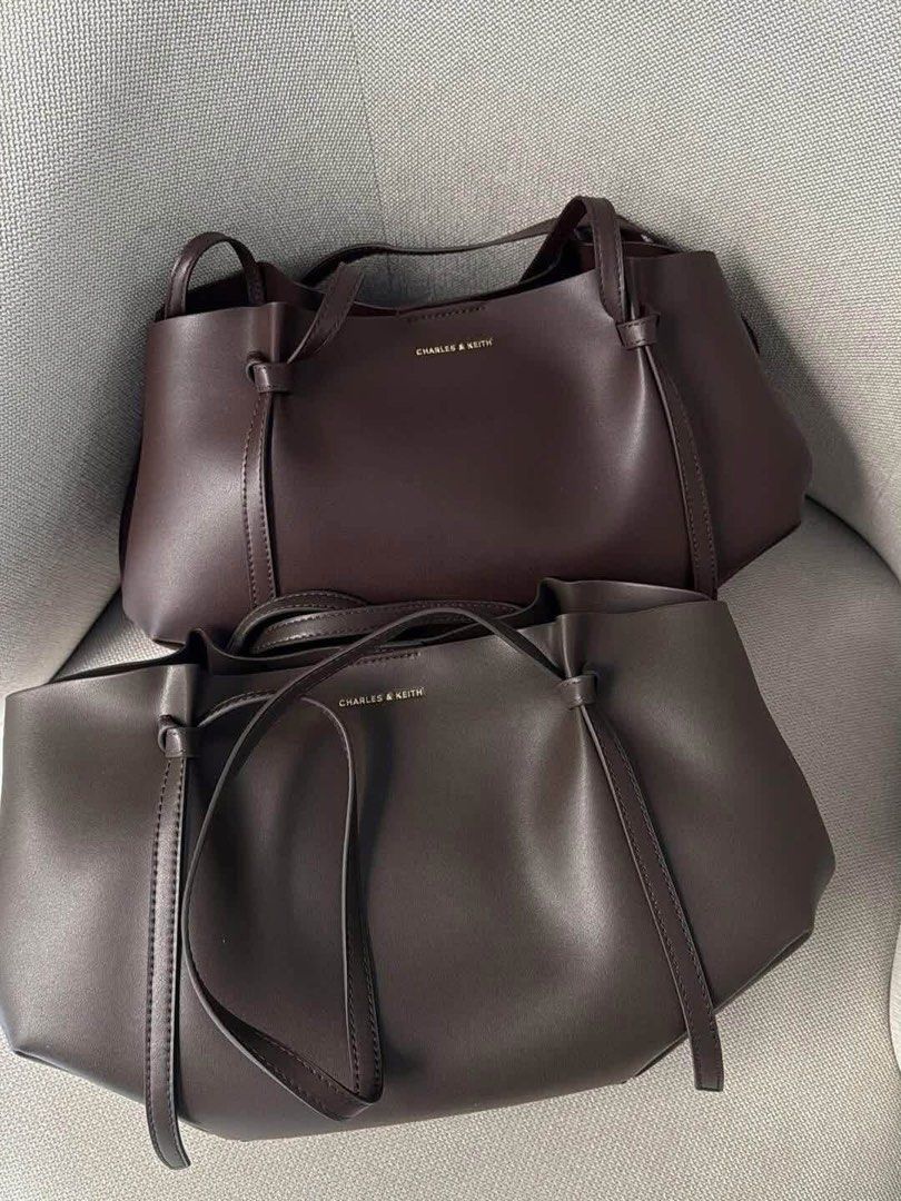 Charles & Keith Dark Brown Tote Bag with Pouch (Category: Tote Bags) located in Pagsanjan. Submitted by jecay00 (Listing ID 1469887277, Image 1). Description: - Brand: Charles & Keith - Color: Rich dark brown - Material: Premium leather - Design: Clean minimalist style with a structured body and thin shoulder straps - Includes: Matching crescent-shaped zip pouch and original dust bag - Features: Spacious interior, perfect for daily essentials - C