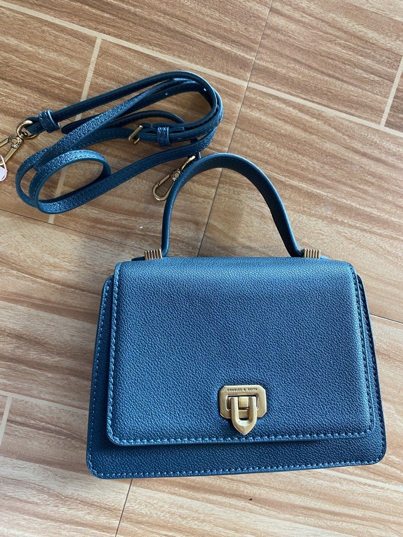 Charles & Keith Metallic Push Lock Top Handle Bag (Category: Cross-body Bags) located in Digos. Submitted by dessirie. (Listing ID 1469820130, Image 3). Description: L= 6 inches | W= 7 inches Authentic from California 📦 We ship anywhere in the Philippines via J&T Express. ❌️No COD – Payment First Policy 📹 We offer video calls for transparency so you can personally inspect your item before shipment. 📝 Layaway terms available 📩For inquiries, re