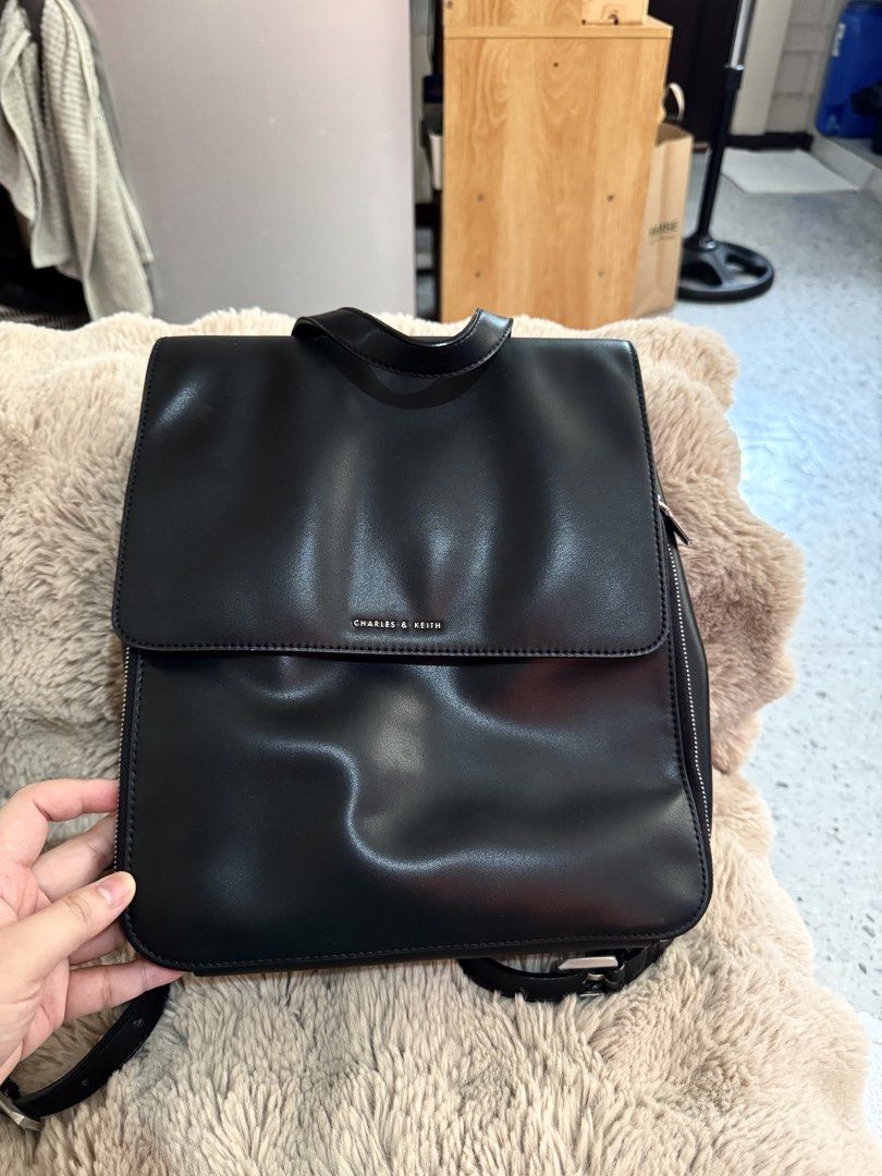 Charles & Keith Octavia Front-Flap Backpack - Noir (Category: Backpacks) located in Pasay City. Submitted by hiyasjewels (Listing ID 1469773220, Image 2). Description: - Brand: Charles & Keith - Model: Octavia Front-Flap Backpack - Color: Classic Black with Silver Hardware - Material: Premium faux leather - Versatility: Top handle and adjustable convertible straps - Closure: Magnetic front flap - Storage: Lined interior with zippered and slip poc