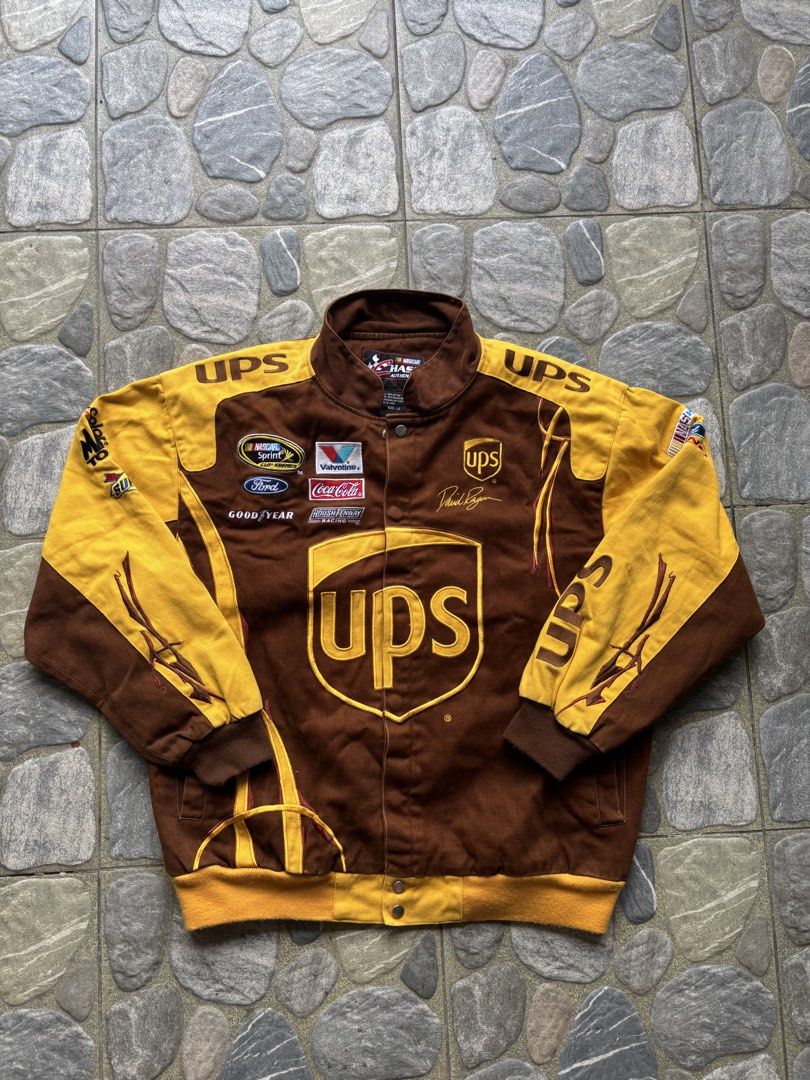 Chase Authentics NASCAR UPS David Ragan Racing Jacket Size L (Category: Coats, Jackets and Outerwear) located in Naga. Submitted by prime.ledesma (Listing ID 1469904950, Image 1). Description: - Brand: Chase Authentics - Driver Edition: David Ragan (#6 UPS) - Color: Brown and Yellow - Size: Large - Material: 100% cotton shell with 100% polyester lining - Closure: Snap button - Details: Multiple embroidered sponsor patches (Sprint, Ford, Valvoline