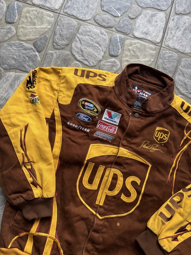 Chase Authentics NASCAR UPS David Ragan Racing Jacket Size L (Category: Coats, Jackets and Outerwear) located in Naga. Submitted by prime.ledesma (Listing ID 1469904950, Image 2). Description: - Brand: Chase Authentics - Driver Edition: David Ragan (#6 UPS) - Color: Brown and Yellow - Size: Large - Material: 100% cotton shell with 100% polyester lining - Closure: Snap button - Details: Multiple embroidered sponsor patches (Sprint, Ford, Valvoline