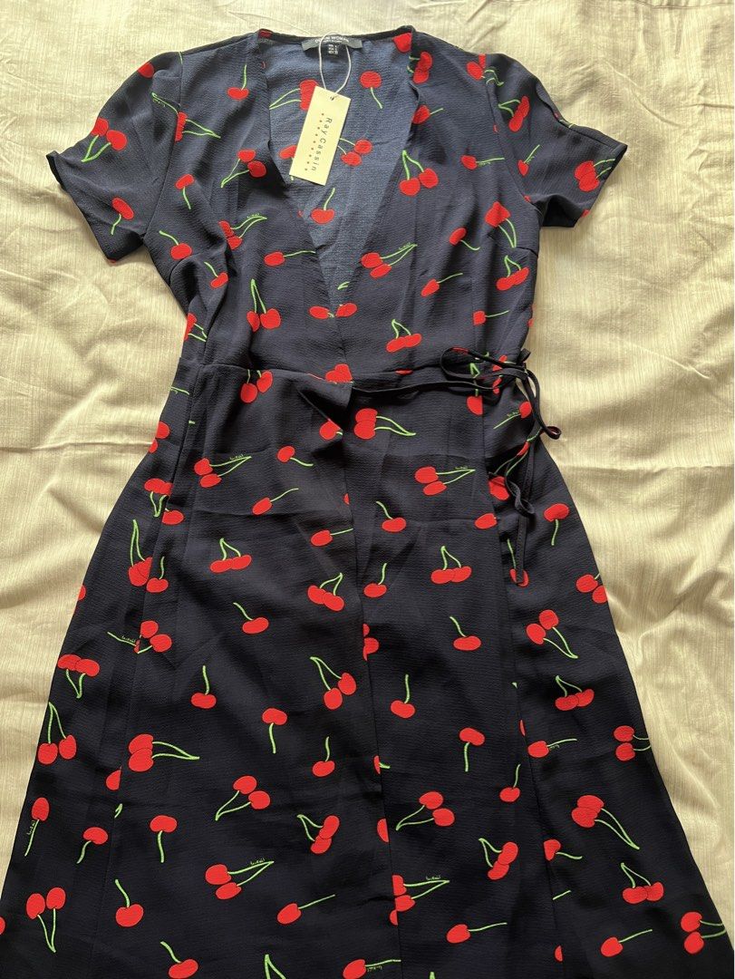 Cherry Print Wrap Tie Dress (Category: Dresses) located in Pasig City. Submitted by jenscloset86 (Listing ID 1469848196, Image 1). Description: BRAND NEW! BRAND NEW! BRAND NEW! Perfect for summer! •Wrap-style dress • Tie waist, so it is adjustable Measurement: LARGE: Waist: 30” Length: 43” Sleeve: 8” Shoulder: 14”.