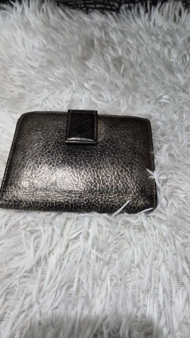 Christian Dior Metallic Bronze Leather Wallet (Category: Luxury Bags & Wallets) located in Baguio. Submitted by jhaz_bags (Listing ID 1469934533, Image 1). Description: - Brand: Christian Dior - Material: Metallic bronze textured leather - Hardware: Polished metal CD buckle - Interior: Multiple card slots and bill compartments - Size: Compact, fits easily into any handbag - Details: Sturdy stitching and solid hardware - Serial Number: IN 02 LU 00
