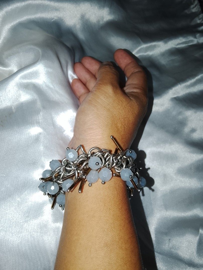 Chunky silver chain bracelet with light blue beads (Category: Bracelets) located in Valenzuela. Submitted by beth45.phoenix (Listing ID 1469923872, Image 1). Description: - Heavy statement chain bracelet with a solid, quality feel - Features a mix of silver links and pale blue faceted beads - Accented with unique bronze-toned metal sticks - Adds wonderful texture, weight, and visual interest - Perfect accessory to dress up a simple, everyday outf