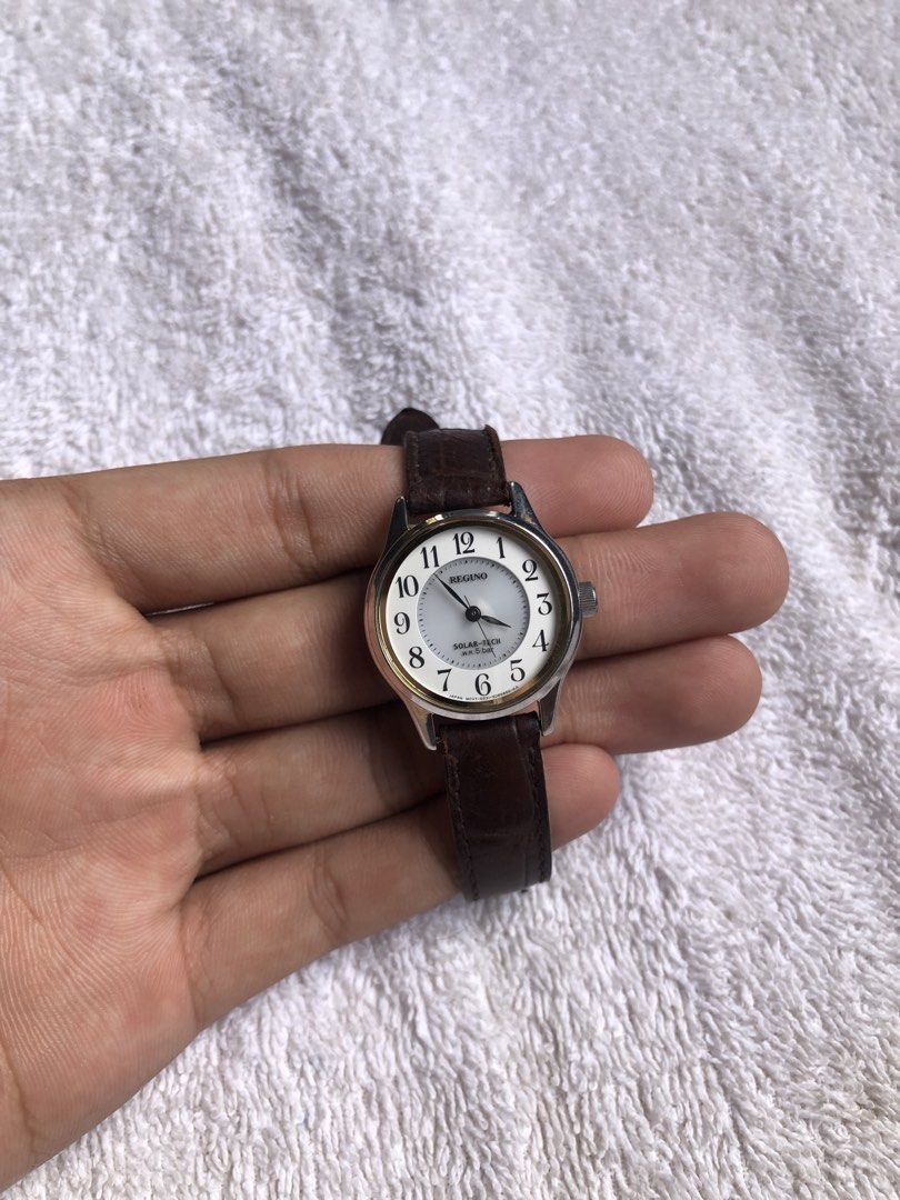 Citizen Reguno Solar-Tech (Category: Women's Watches) located in Dagupan City. Submitted by alex123345 (Listing ID 1469912470, Image 1). Description: Citizen Reguno Solar-Tech Brand: Reguno (Sub-brand of Citizen) Model: Reguno Solar-Tech Ladies Reference: E011-0088591 / E011-H28840 Watch Movement: Citizen Caliber E011 Solar Quartz Power Source: Solar Powered / Light-driven Dial Details: White Textured Dial with Arabic Numerals, Leaf-style Hands C