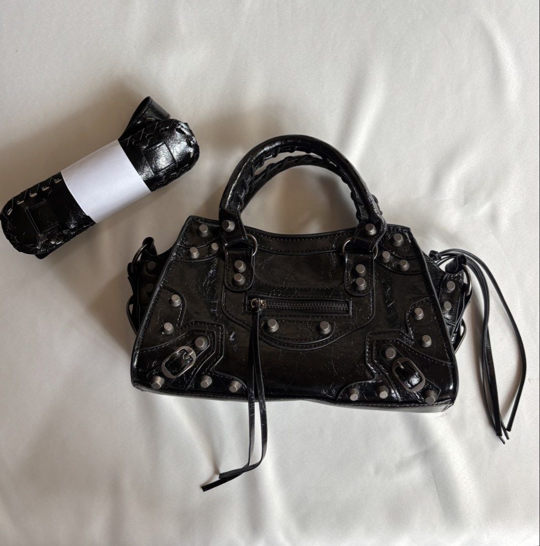 City Bag inspired (Category: Luxury Bags & Wallets) located in Iloilo. Submitted by iconicangie (Listing ID 1469918373, Image 1). Description: - Material: Black crinkled leather with striking metal hardware studs - Handles & Straps: Dual braided top handles and an included rolled shoulder strap - Pockets: Convenient front zip pocket with tassel pulls and a secure interior zip pocket - Closure: Top zip closure to keep your belongings safe - Interi