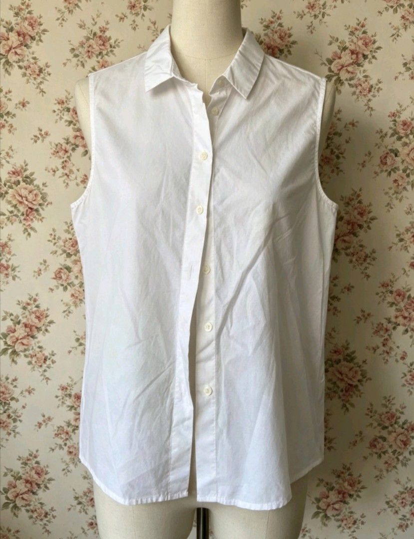 Classic White Sleeveless Button-Down Shirt (Category: Sleeveless) located in Manila. Submitted by charlottej01596 (Listing ID 1469811785, Image 1). Description: - Style: Classic sleeveless button-up shirt with a tailored fit - Material: Lightweight, breathable cotton (ideal for warm weather or layering) - Details: Classic collar, small white buttons, standard hip-length hem - Versatility: A must-have wardrobe basic that easily pairs with skirts, 