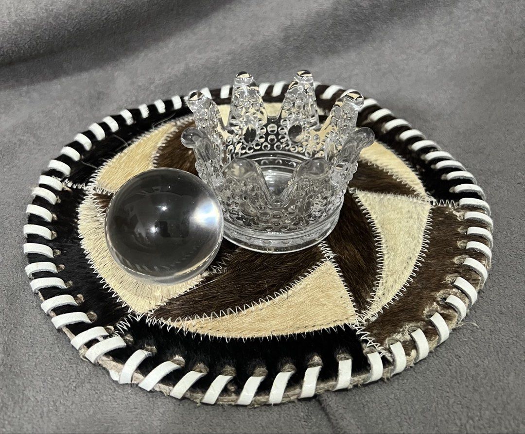 Clear Glass Crystal Ball with Crown Stand (Category: Vases & Decorative Bowls) located in Las Pinas. Submitted by maple0305 (Listing ID 1469095363, Image 3). Description: - Clear glass crystal sphere with solid weight - Intricate crown-shaped glass holder included - Comes with a stylish circular patterned leather and hide coaster mat - Perfect decor piece for desks or shelves - Flawless condition with no chips or cracks.