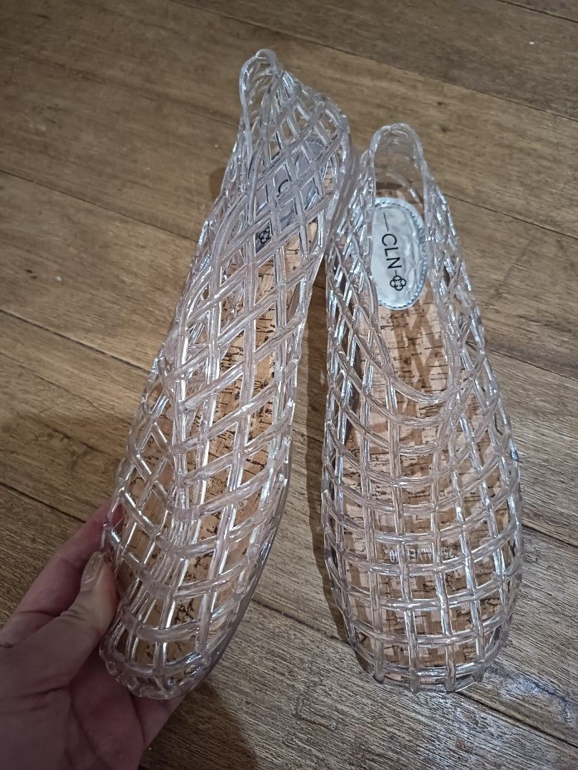 CLN Clear Jelly Flats Sandals (Category: Flats & Sandals) located in Las Pinas. Submitted by organizeaway (Listing ID 1469820003, Image 2). Description: - Brand: CLN - Style: Clear jelly sandals with woven cage design - Footbed: Cork-style with silver branding on the insole - Features: Slip-on style, easy to wear - Ideal for: Rainy days or casual daily outings - Condition: Clean soles and insoles, well-maintained.