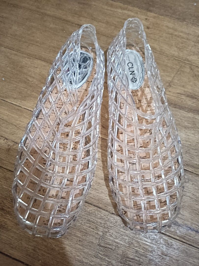 CLN Clear Jelly Flats Sandals (Category: Flats & Sandals) located in Las Pinas. Submitted by organizeaway (Listing ID 1469820003, Image 1). Description: - Brand: CLN - Style: Clear jelly sandals with woven cage design - Footbed: Cork-style with silver branding on the insole - Features: Slip-on style, easy to wear - Ideal for: Rainy days or casual daily outings - Condition: Clean soles and insoles, well-maintained.