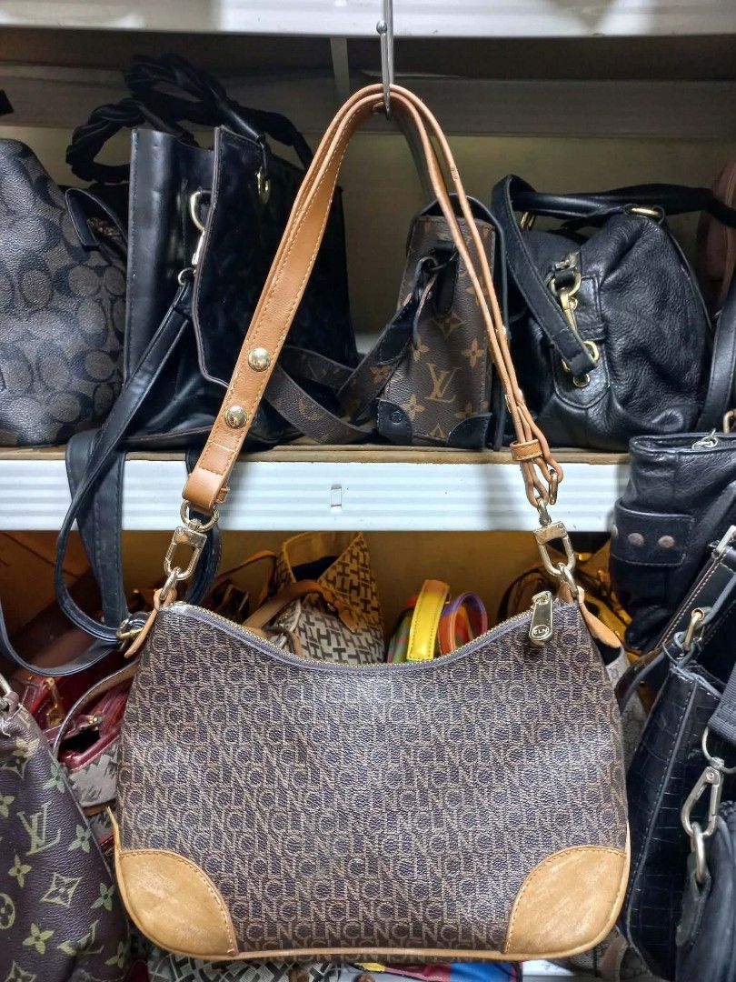 SOLD CLN Monogram Shoulder Bag Brown Tan (Category: Luxury Bags & Wallets) located in Manila. Submitted by dei03_diz (Listing ID 1469811341, Image 2). Description: - Brand: CLN - Design: Brown monogram print with tan leather-look trim - Strap: Adjustable - Closure: Zip top - Interior: Satin lining with inner zip pocket and brand plaque - Condition: Clean inside and out - Usage: Handy daily bag normal signs of usage in CLN .