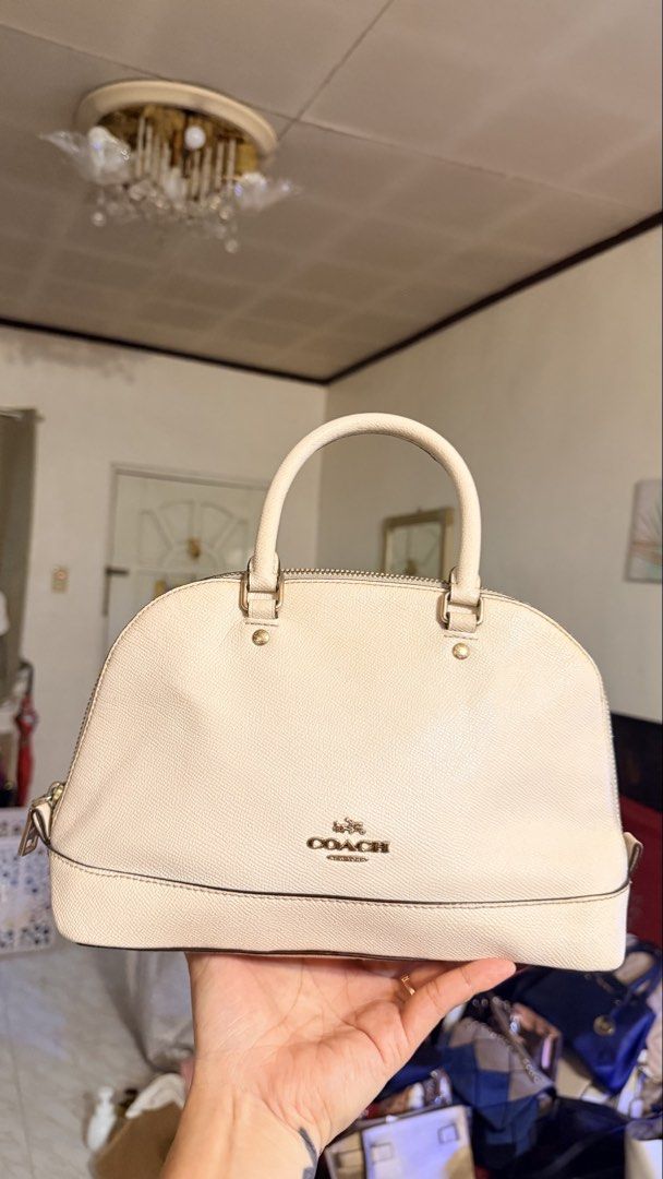 Coach Beige Leather Dome Satchel Handbag (Category: Luxury Bags & Wallets) located in Manila. Submitted by iamrfe (Listing ID 1469871286, Image 1). Description: - Brand: Coach - Style: Dome Satchel / Everyday Bag - Material: Textured beige leather - Hardware: Gold tone with zip closure - Details: Dual top handles, Coach New York front logo - Size: Compact and practical for daily use.