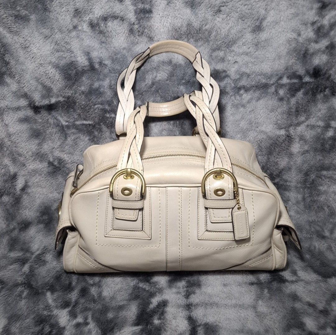 Coach Beige Leather Handbag with Braided Handles (Category: Luxury Bags & Wallets) located in Sorsogon. Submitted by johnmichae69459 (Listing ID 1469851961, Image 1). Description: - Y2k Coach mia soho bag - Genuine cream leather exterior with classic brass hardware - Comfortable braided shoulder handles and secure zip-top closure - Practical external buckle pockets on the sides and front - Includes matching Coach leather hangtag - Clean, versatil