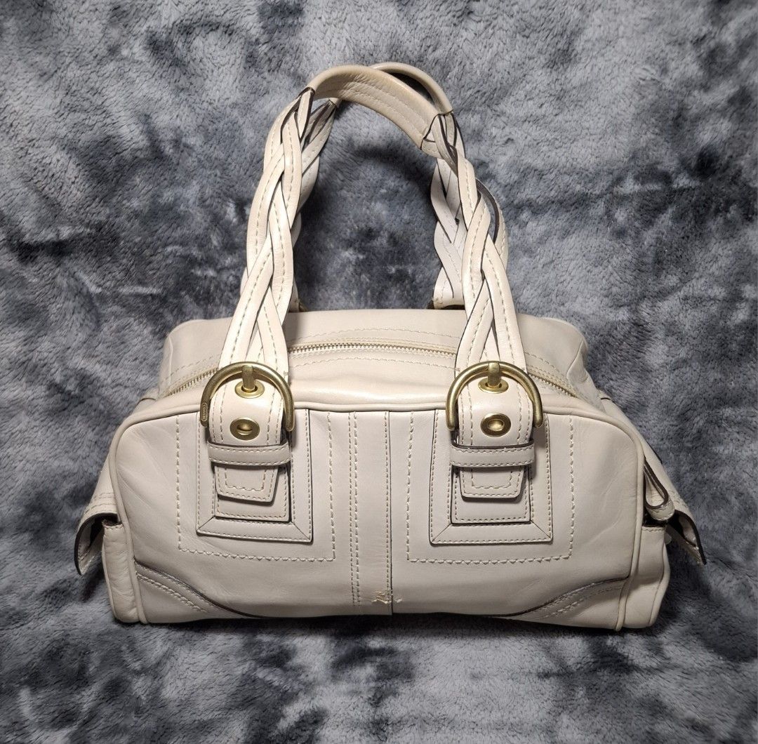 Coach Beige Leather Handbag with Braided Handles (Category: Luxury Bags & Wallets) located in Sorsogon. Submitted by johnmichae69459 (Listing ID 1469851961, Image 2). Description: - Y2k Coach mia soho bag - Genuine cream leather exterior with classic brass hardware - Comfortable braided shoulder handles and secure zip-top closure - Practical external buckle pockets on the sides and front - Includes matching Coach leather hangtag - Clean, versatil