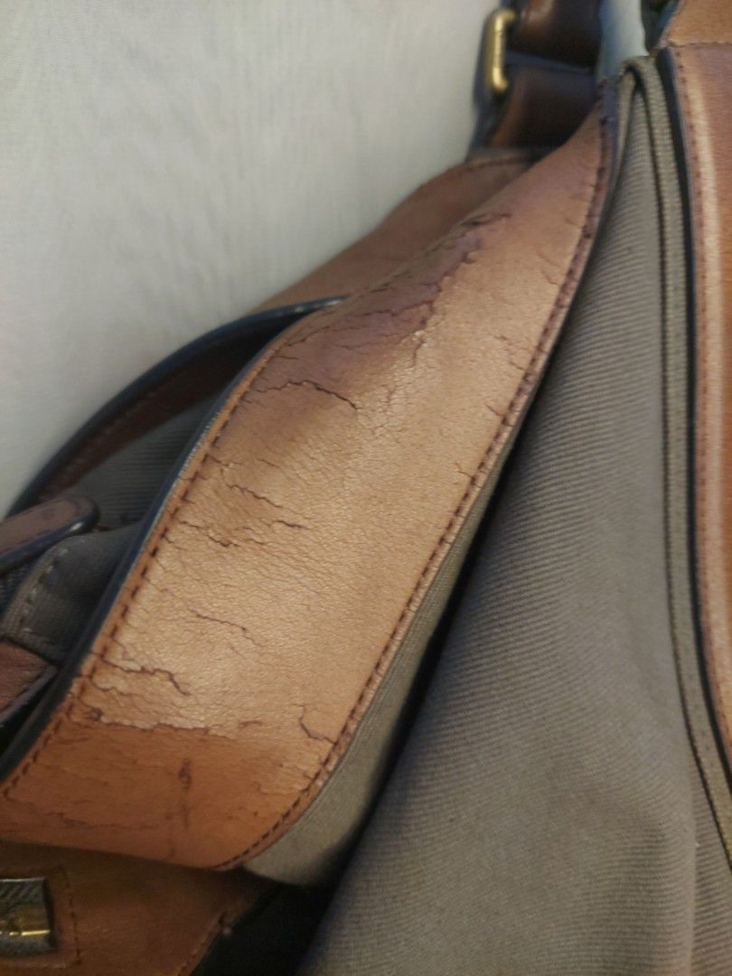 Coach canvas and leather shoulder bag (Category: Luxury Bags & Wallets) located in Quezon City. Submitted by never_a_clutter (Listing ID 1469884908, Image 2). Description: - Authentic Coach shoulder bag in gray canvas with brown leather trim - Features durable brass hardware and protective metal feet on the bottom base - Double top handles and includes the classic Coach hangtag - Spacious interior perfect for your daily essentials - Flaw note: He