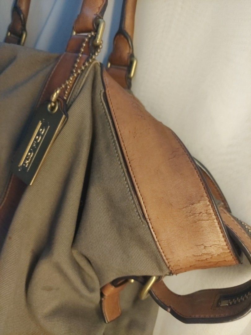 Coach canvas and leather shoulder bag (Category: Luxury Bags & Wallets) located in Quezon City. Submitted by never_a_clutter (Listing ID 1469884908, Image 3). Description: - Authentic Coach shoulder bag in gray canvas with brown leather trim - Features durable brass hardware and protective metal feet on the bottom base - Double top handles and includes the classic Coach hangtag - Spacious interior perfect for your daily essentials - Flaw note: He