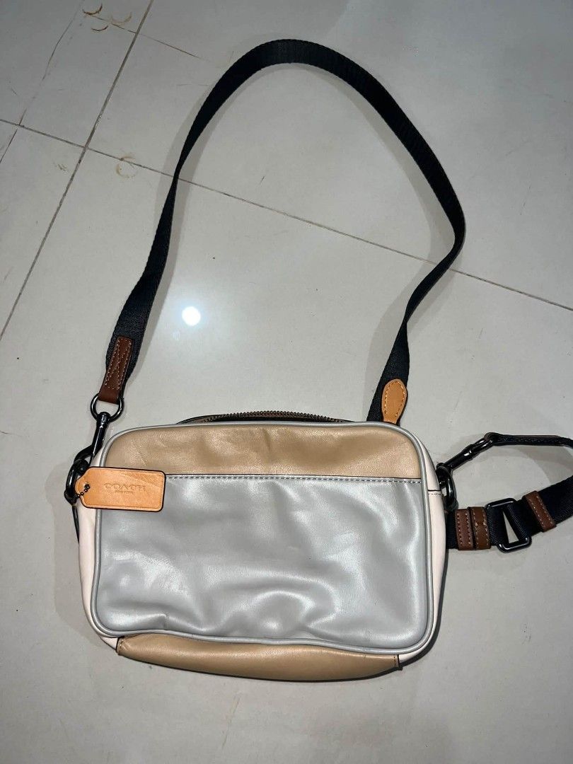 Coach Colorblock Leather Crossbody Bag (Category: Cross-body Bags) located in Manila. Submitted by zackthrift16 (Listing ID 1469868521, Image 2). Description: - Authentic Coach crossbody bag - Colorway: Stylish mix of grey, tan, and cream leather - Storage: Front zippered pocket with Coach logo patch, plus a convenient back slip pocket - Strap: Adjustable black and brown webbing strap with dark metal hardware - Extras: Includes signature leather 