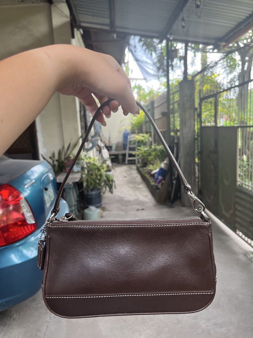 Coach Demi Dark Brown Leather Bag (Category: Luxury Bags & Wallets) located in General Santos City (Dadiangas). Submitted by cinnamongirlypop (Listing ID 1469504893, Image 1). Description: - Authentic Coach dark brown leather shoulder bag - Trendy Y2K structured rectangular silhouette - Secure zip-top closure with original Coach hangtag - Elegant contrast stitching and silver-tone hardware - Single thin strap for comfortable shoulder wear - Clean