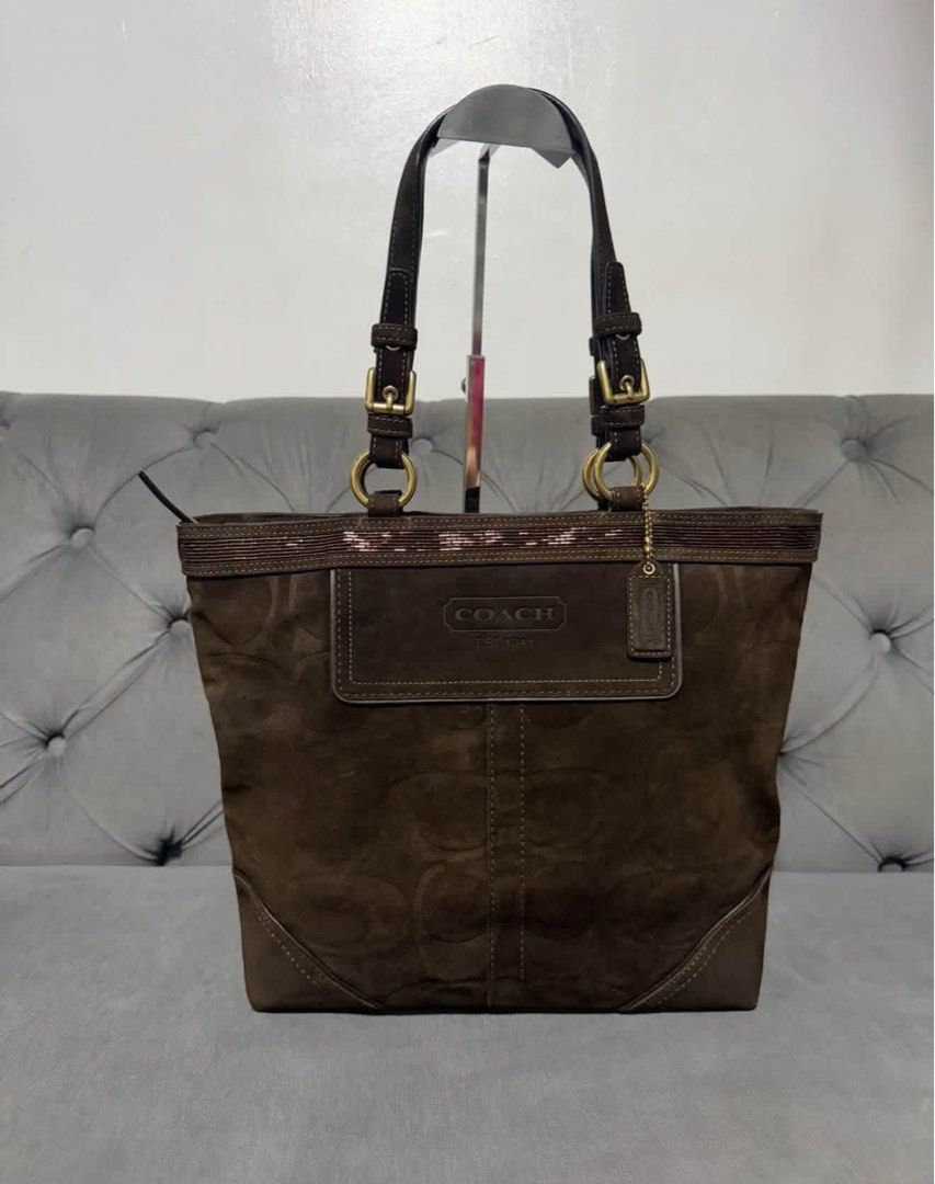 Coach Pink Carriage Print Tote Bag (Category: Luxury Bags & Wallets) located in Calamba. Submitted by saiphsavion (Listing ID 1469930713, Image 2). Description: - Authentic Coach tote bag in a chic pink monogram carriage and horse print - Features white leather straps, trim, and a stylish hanging luggage tag - Secure front metal clasp closure with sleek silver hardware - Spacious fabric interior, perfect for books, wallets, and daily essentials -