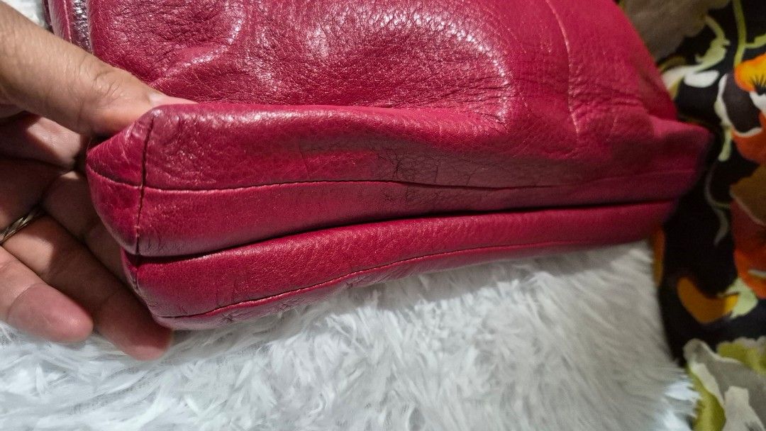 Coach Pink Leather Shoulder Bag (Category: Luxury Bags & Wallets) located in Baguio. Submitted by jhaz_bags (Listing ID 1469902493, Image 3). Description: - Brand: Coach - Material: Bright pink pebbled leather with gold-tone hardware - Closure: Secure turnlock closure - Interior: Brown satin lining with a zippered pocket and stamped serial number creed patch - Strap: Detachable chain and leather shoulder strap - Condition: Slight wear around the 