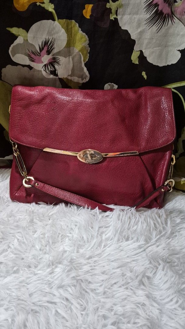 Coach Pink Leather Shoulder Bag (Category: Luxury Bags & Wallets) located in Baguio. Submitted by jhaz_bags (Listing ID 1469902493, Image 1). Description: - Brand: Coach - Material: Bright pink pebbled leather with gold-tone hardware - Closure: Secure turnlock closure - Interior: Brown satin lining with a zippered pocket and stamped serial number creed patch - Strap: Detachable chain and leather shoulder strap - Condition: Slight wear around the 