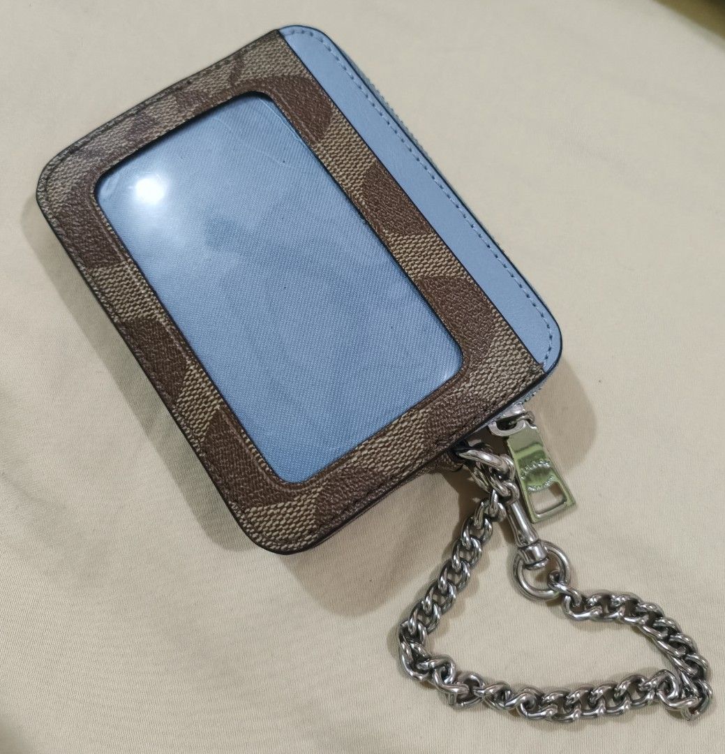 Coach Signature Canvas Card Case Wallet Light Blue (Category: Luxury Bags & Wallets) located in Capas. Submitted by rayapretty55453 (Listing ID 1469909151, Image 3). Description: - 100% Authentic Coach card case wallet - Signature monogram canvas with stylish light blue leather trim - Secure top zip compartment with polished silver hardware - Convenient chain strap with dog leash clasp - Clear ID window on the back for easy access - Multiple card