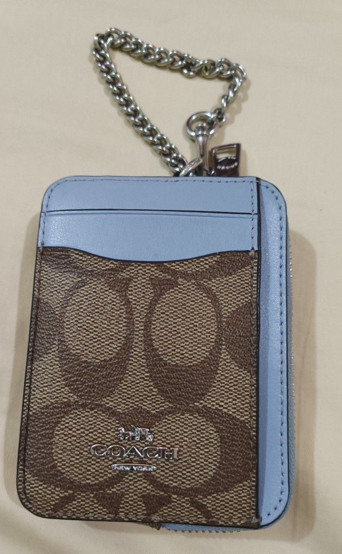 Coach Signature Canvas Card Case Wallet Light Blue (Category: Luxury Bags & Wallets) located in Capas. Submitted by rayapretty55453 (Listing ID 1469909151, Image 1). Description: - 100% Authentic Coach card case wallet - Signature monogram canvas with stylish light blue leather trim - Secure top zip compartment with polished silver hardware - Convenient chain strap with dog leash clasp - Clear ID window on the back for easy access - Multiple card