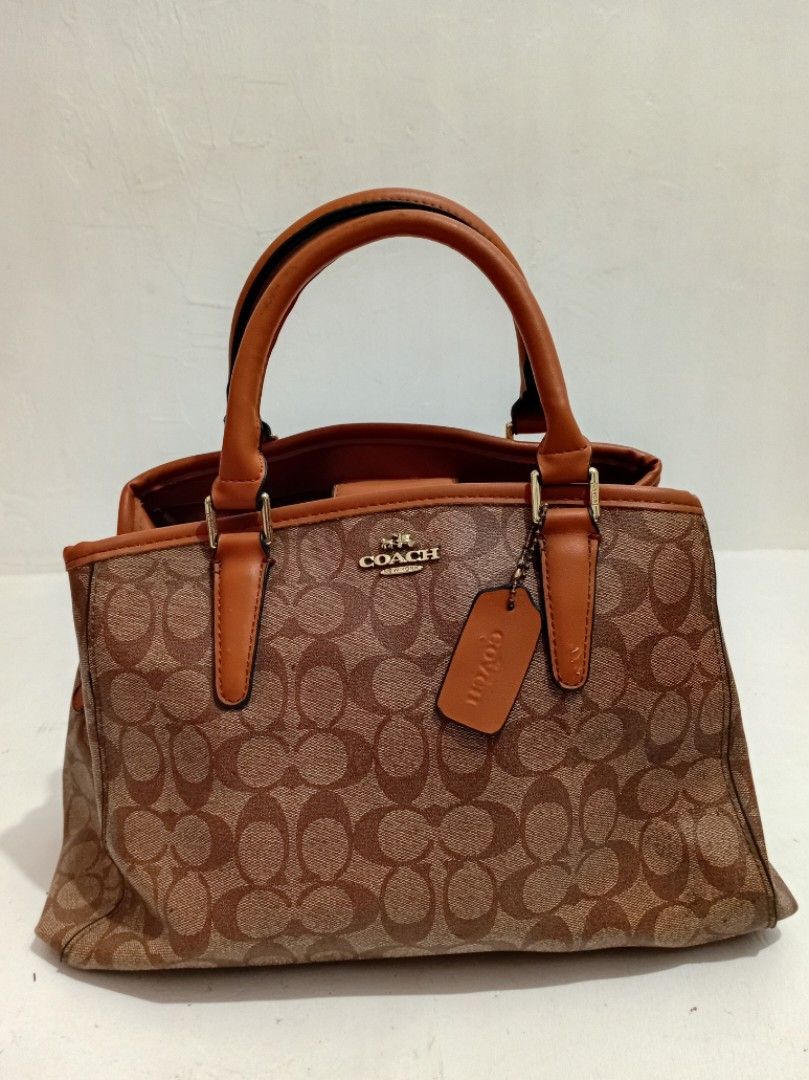 Coach Signature Monogram Brown Tote Handbag (Category: Luxury Bags & Wallets) located in Manila. Submitted by eriiicaspage (Listing ID 1469874292, Image 1). Description: PreOwned LikeNew Lightly Used Coach signature monogram Canvas &leather Large Satchel bag in classic brown and tan (NGA ) Medium-Large - Dual structured handles with elegant gold-tone hardware and matching hangtag - Secure magnetic snap closure with protective metal feet on the ba
