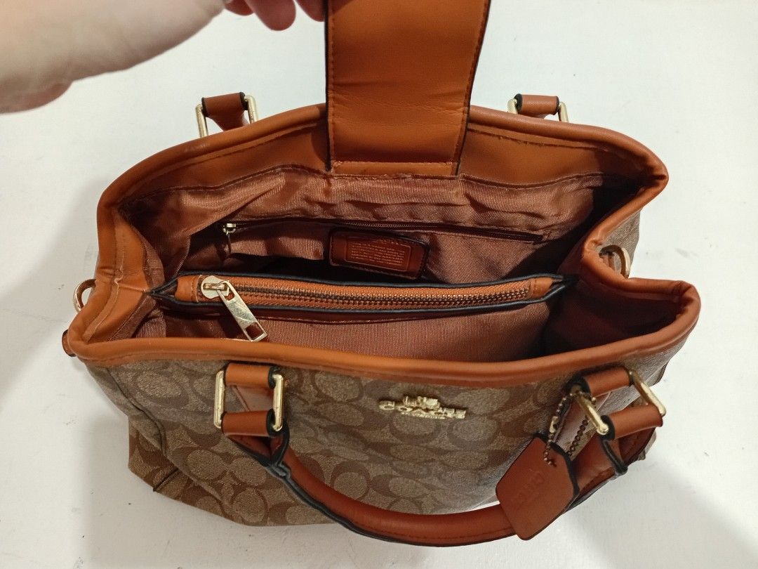 Coach Signature Monogram Brown Tote Handbag (Category: Luxury Bags & Wallets) located in Manila. Submitted by eriiicaspage (Listing ID 1469874292, Image 3). Description: PreOwned LikeNew Lightly Used Coach signature monogram Canvas &leather Large Satchel bag in classic brown and tan (NGA ) Medium-Large - Dual structured handles with elegant gold-tone hardware and matching hangtag - Secure magnetic snap closure with protective metal feet on the ba