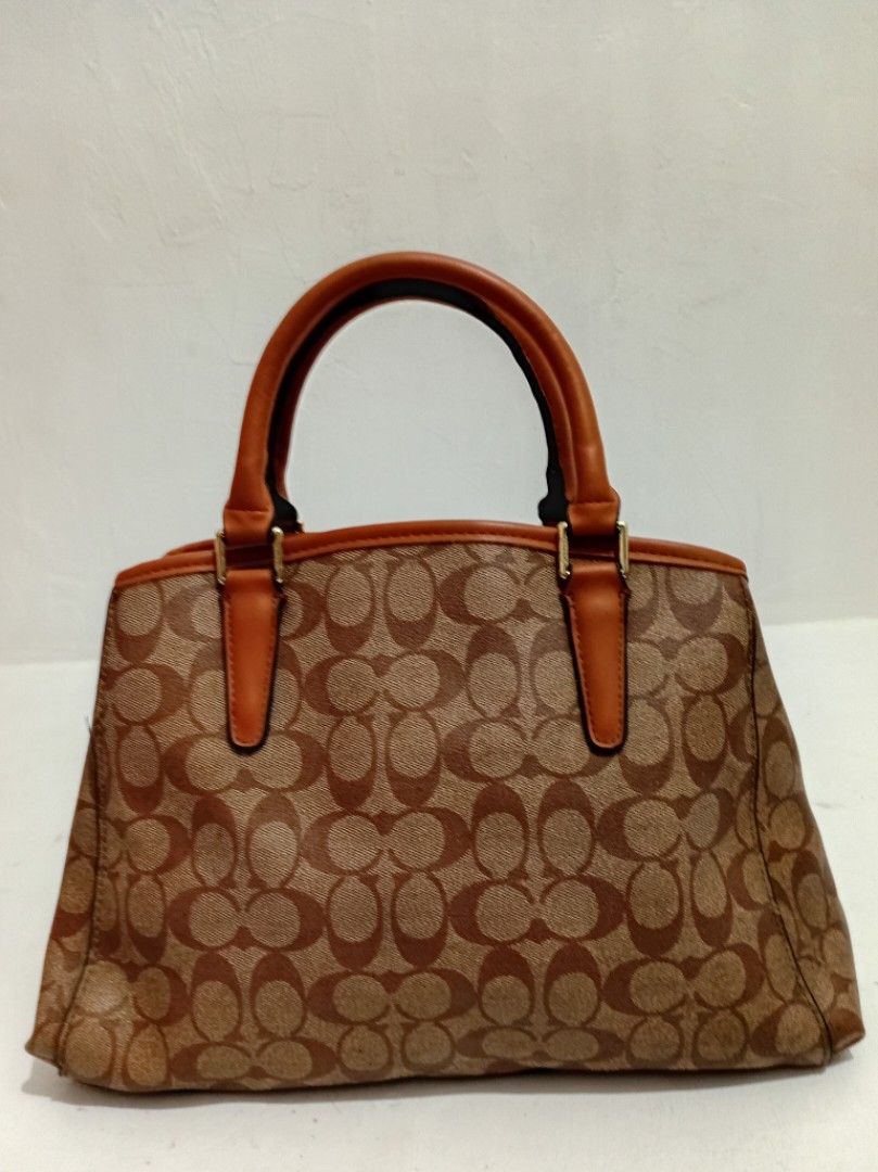Coach Signature Monogram Brown Tote Handbag (Category: Luxury Bags & Wallets) located in Manila. Submitted by eriiicaspage (Listing ID 1469874292, Image 2). Description: PreOwned LikeNew Lightly Used Coach signature monogram Canvas &leather Large Satchel bag in classic brown and tan (NGA ) Medium-Large - Dual structured handles with elegant gold-tone hardware and matching hangtag - Secure magnetic snap closure with protective metal feet on the ba