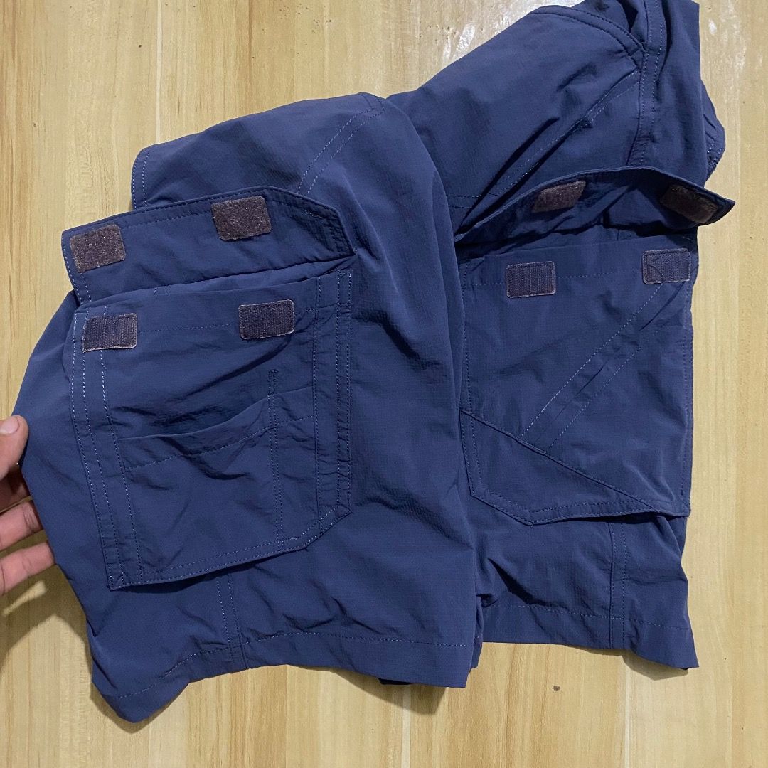 Columbia Blue Cargo Shorts Size 31-32 (Category: Shorts) located in Bacolod City. Submitted by jeybe112019 (Listing ID 1469897749, Image 3). Description: - Brand: Columbia - Color: Dark Blue - Size: Tagged 85 (L), fits waist 31-32 - Material: Lightweight nylon, ideal for outdoor hiking or casual wear - Features: Multiple utility pockets with velcro flaps on sides and back, standard button closure, and belt loops - Condition: Clean all around.