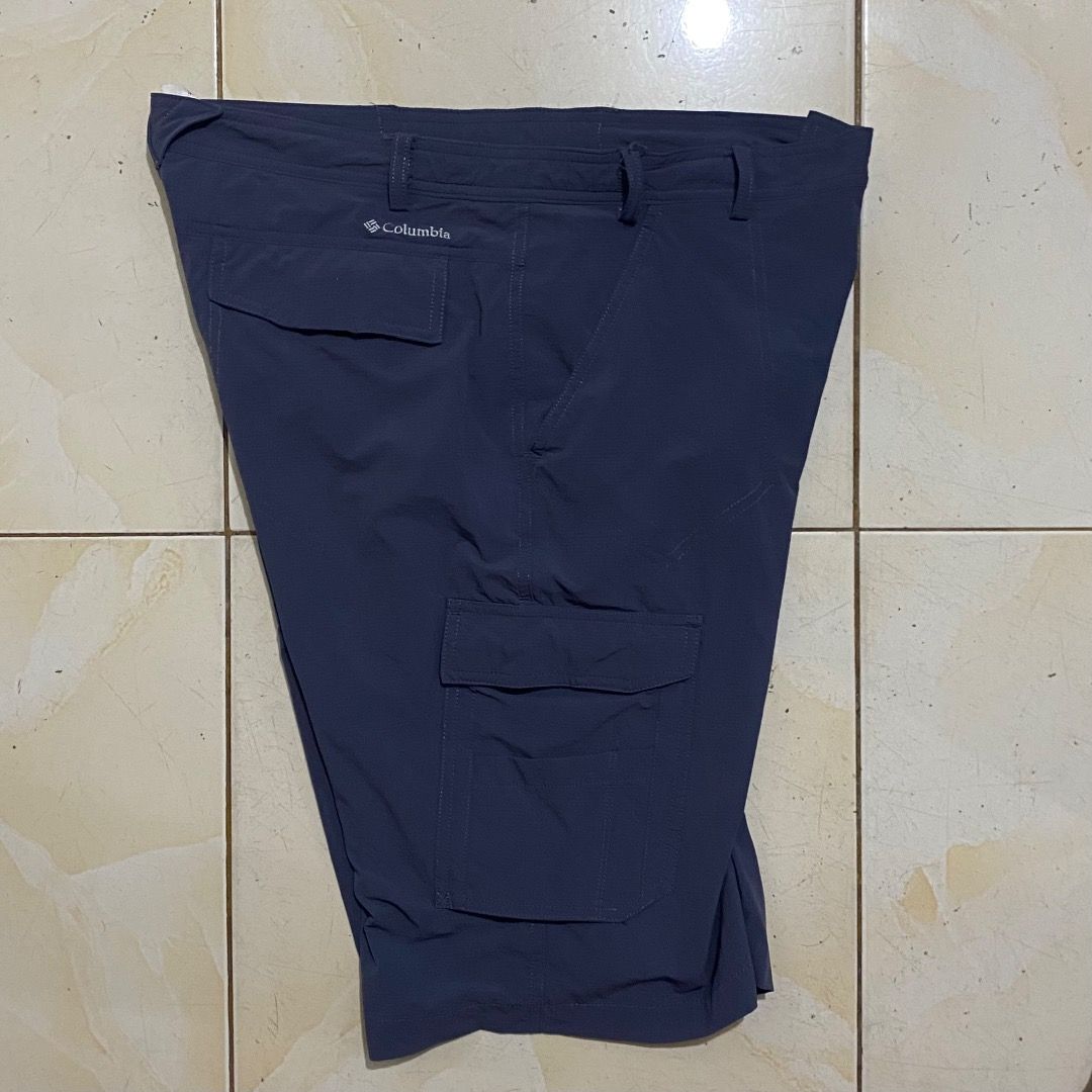 Columbia Blue Cargo Shorts Size 31-32 (Category: Shorts) located in Bacolod City. Submitted by jeybe112019 (Listing ID 1469897749, Image 2). Description: - Brand: Columbia - Color: Dark Blue - Size: Tagged 85 (L), fits waist 31-32 - Material: Lightweight nylon, ideal for outdoor hiking or casual wear - Features: Multiple utility pockets with velcro flaps on sides and back, standard button closure, and belt loops - Condition: Clean all around.