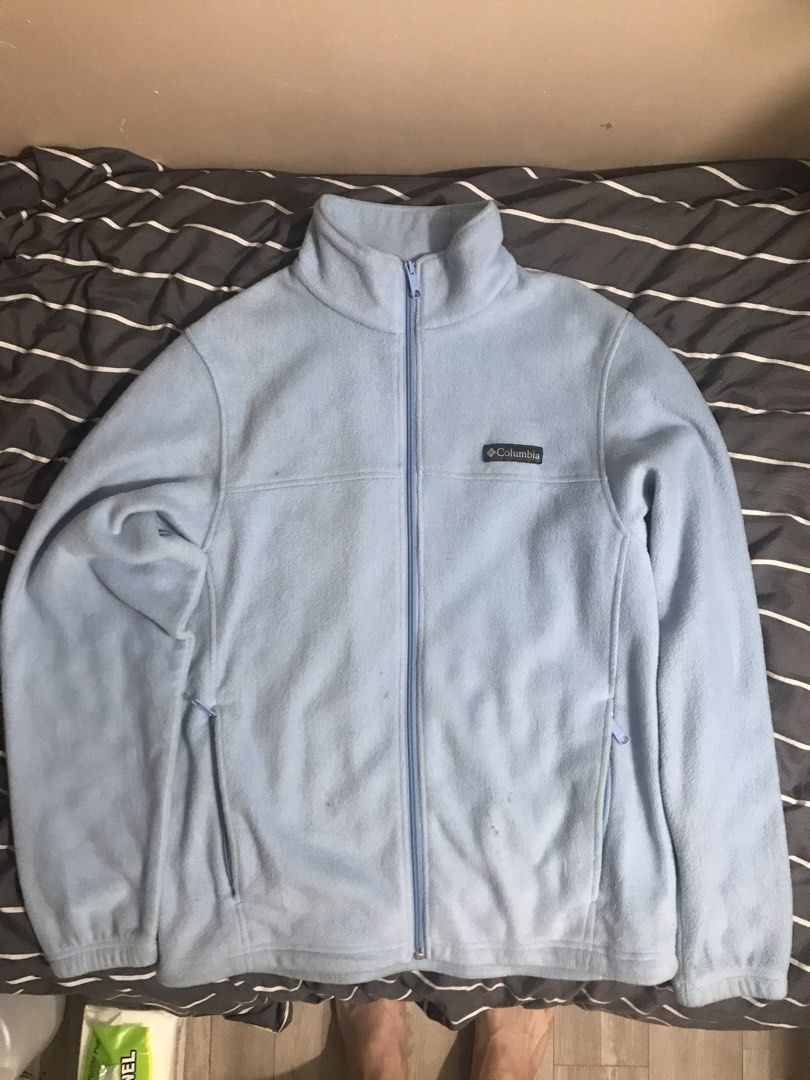 Columbia Light Blue Fleece Jacket (Category: Coats, Jackets and Outerwear) located in Baguio. Submitted by mintchoc1 (Listing ID 1469816953, Image 1). Description: - Brand: Columbia - Color: Light/Baby Blue - Size: Medium - Material: Soft and cozy fleece - Features: Full-zip closure, high collar for extra warmth, and two zippered side pockets - Details: Embroidered Columbia logo on the left chest and solid back - Condition: Great for layering on 