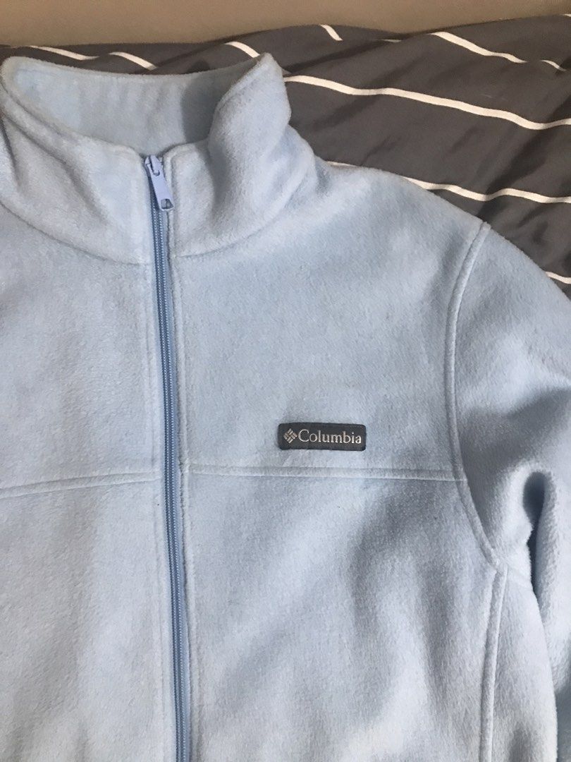 Columbia Light Blue Fleece Jacket (Category: Coats, Jackets and Outerwear) located in Baguio. Submitted by mintchoc1 (Listing ID 1469816953, Image 2). Description: - Brand: Columbia - Color: Light/Baby Blue - Size: Medium - Material: Soft and cozy fleece - Features: Full-zip closure, high collar for extra warmth, and two zippered side pockets - Details: Embroidered Columbia logo on the left chest and solid back - Condition: Great for layering on 
