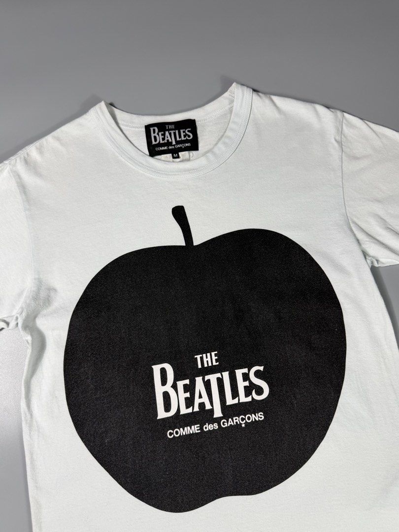 Comme Des Garcons x The Beatles Apple Tee (Category: Tshirts & Polo Shirts ) located in Manila. Submitted by whowearsstreetwear (Listing ID 1469923191, Image 3). Description: Comme Des Garcons x The Beatles Apple Tee (Authentic) - Size: Medium on tag (measurements in inches) W - 19 L - 26 Condition: Excellent Flaw/s: none + shipping fee Location: Manila (Near UST).