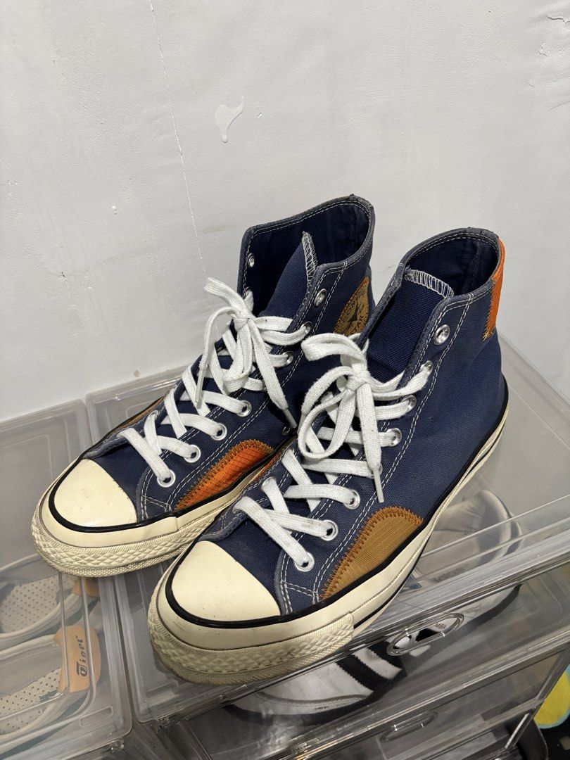 Converse Chuck 70 High Top Blue Orange Patchwork Sneakers (Category: Sneakers) located in San Mateo. Submitted by prelovedbychaaar (Listing ID 1469773815, Image 1). Description: - Brand: Converse Chuck 70 High Top - Colorway: Navy blue with orange and tan patchwork accents - Features: Ripstop paneling, exposed zig-zag stitching, classic white toe cap, and black foxing stripes - Condition: Pre-loved - Perfect for daily street wear and collectors I