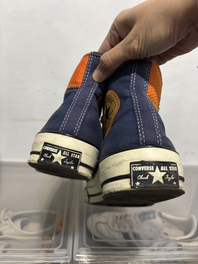 Converse Chuck 70 High Top Blue Orange Patchwork Sneakers (Category: Sneakers) located in San Mateo. Submitted by prelovedbychaaar (Listing ID 1469773815, Image 2). Description: - Brand: Converse Chuck 70 High Top - Colorway: Navy blue with orange and tan patchwork accents - Features: Ripstop paneling, exposed zig-zag stitching, classic white toe cap, and black foxing stripes - Condition: Pre-loved - Perfect for daily street wear and collectors I
