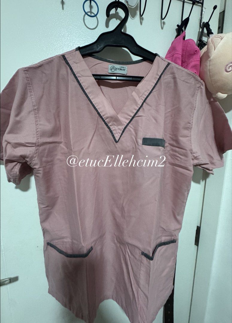 Cotton Fit Pink Scrubs Set Size Large (Category: Sets or Coordinates) located in Pasay City. Submitted by michmonteros (Listing ID 1469871322, Image 1). Description: - Brand: Cotton Fit - Color: Pink with contrasting dark grey trim - Set includes: V-neck top with pockets and matching pants with elastic waistband - Top measurements: Shoulder 48cm, Width 54cm, Length 68cm - Pants measurements: Relaxed waist 28cm (stretched up to 44cm), Length 89cm 