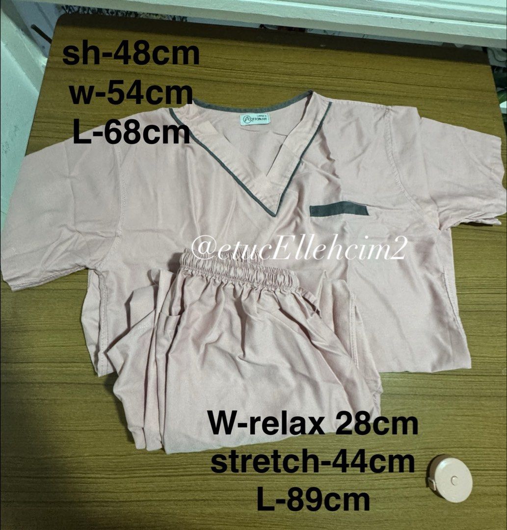 Cotton Fit Pink Scrubs Set Size Large (Category: Sets or Coordinates) located in Pasay City. Submitted by michmonteros (Listing ID 1469871322, Image 2). Description: - Brand: Cotton Fit - Color: Pink with contrasting dark grey trim - Set includes: V-neck top with pockets and matching pants with elastic waistband - Top measurements: Shoulder 48cm, Width 54cm, Length 68cm - Pants measurements: Relaxed waist 28cm (stretched up to 44cm), Length 89cm 